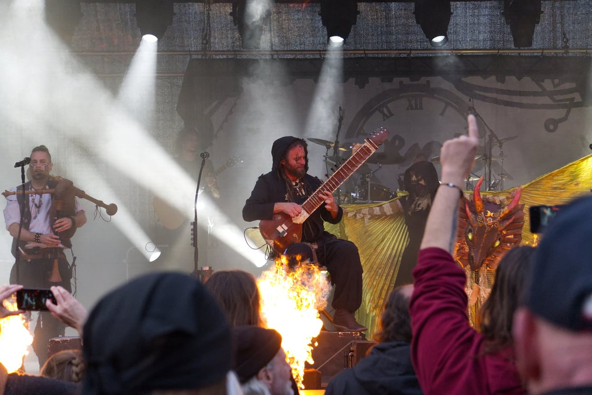 Band KOENIX live on stage with fire shooting up from the stage